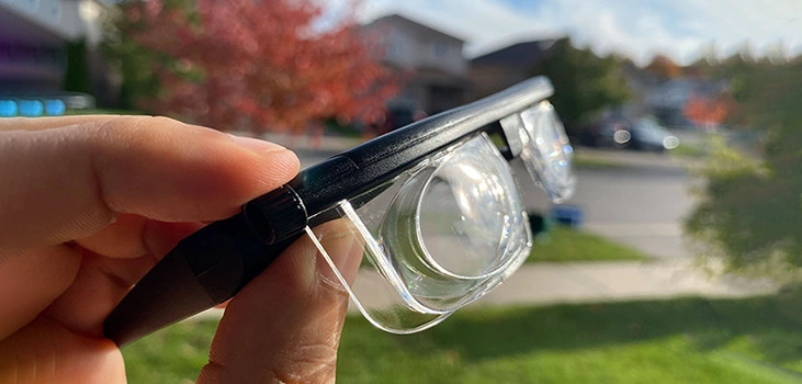 Vision Pro-glasses-man-holding-the-glasses-in-his-backyard