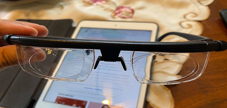 man holding adjustable glasses in his hand